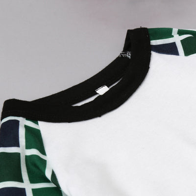 Matching family Christmas pajamas with white and black raglan tops featuring a green Christmas tree graphic and plaid pants. - Image 9
