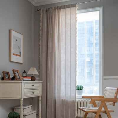 Black polyester curtain with white jacquard multi-line pattern and black tassels, draped over a white chair. - Image 14