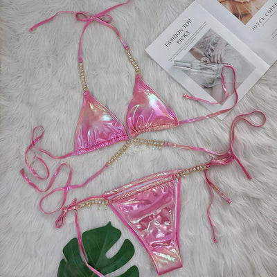 Iridescent purple and pink two-piece bikini with gold-toned crystal embellishments on a white faux fur background. - Image 8