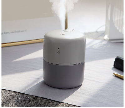 Coral desktop humidifier with a modern cylindrical design, featuring a green indicator light and a power button. - Image 13