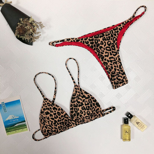 Leopard print two-piece bikini with a triangle top and high-cut bottom, modeled on a sandy beach. - Image 14