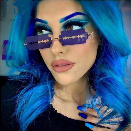 Orange razor blade shaped rimless sunglasses with gold metal frames and black ear tips on a white background. - Image 12