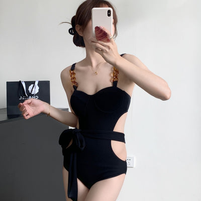 Black ribbed one-piece swimsuit with sweetheart neckline, chain-link shoulder strap, side cut-outs, and self-tie waist. - Image 3