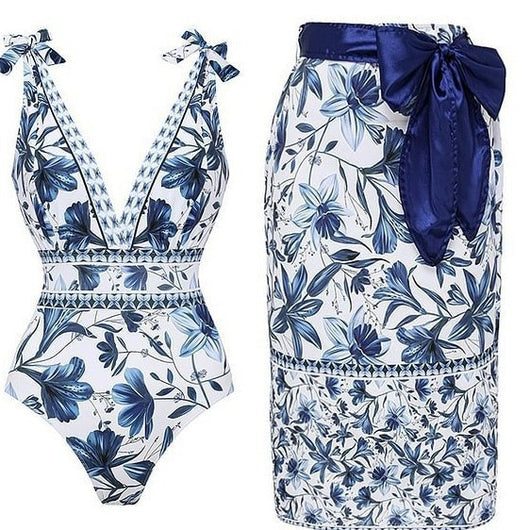 Women's white one-piece swimsuit with deep V-neck, blue floral and geometric patterns, and tie-shoulder straps. - Image 2