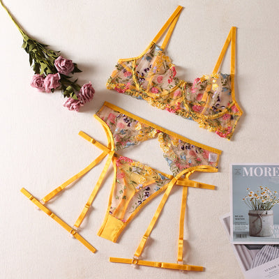 Yellow sheer floral embroidered lingerie set with a bra, thong, and two leg rings, laid flat. - Image 6