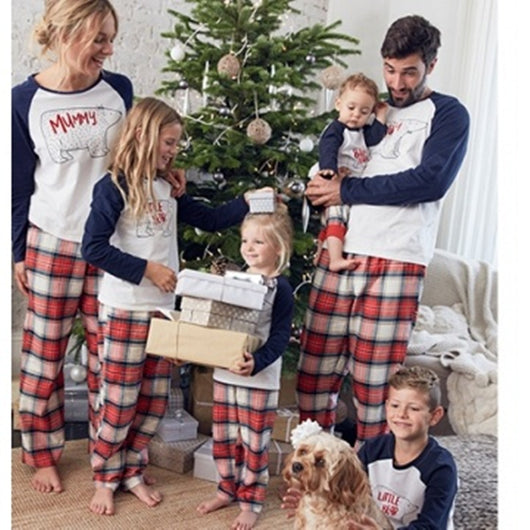Family of four wearing matching Christmas pajamas with white and navy bear print tops and red plaid pants. - Image 3