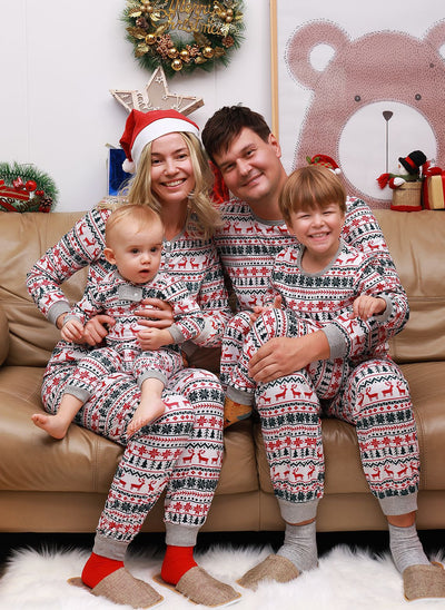 Family of four wearing matching white, red, and green fair isle Christmas pajamas with reindeer and snowflake patterns. - Image 7