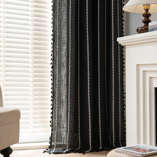 Black polyester curtain with white jacquard multi-line pattern and black tassels, draped over a white chair. - Image 24