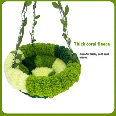 Small forest style plush bird hammock in green and yellow, hanging from a chain with artificial leaves. - Image 5