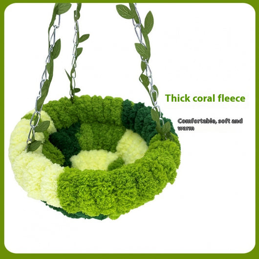 Small forest style plush bird hammock in green and yellow, hanging from a chain with artificial leaves. - Image 5