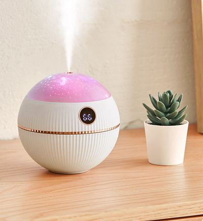 Pink spherical humidifier with a white top, ribbed texture, rose gold band, and a digital display showing 73%. - Image 11