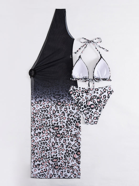 Woman in a three-piece leopard print bikini and sheer black sarong cover-up on a sunny beach. - Image 13
