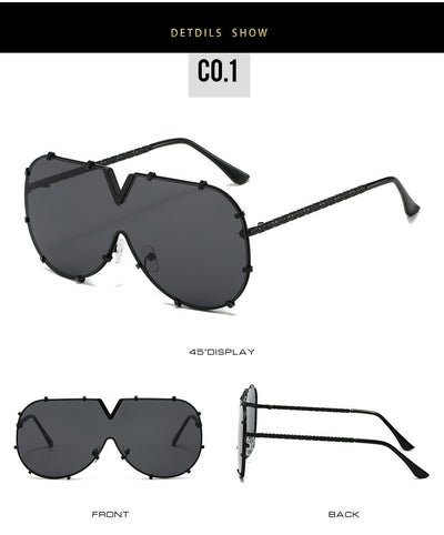 Oversized V-shaped sunglasses with a gold metal frame, white accents, clear lenses, and decorative rivets. - Image 22