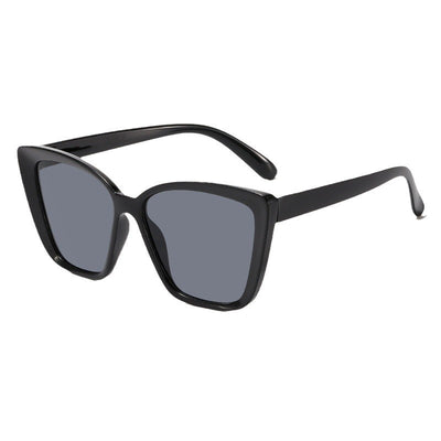 Clear large-frame square glasses held by a hand in a grey knitted sweater, showcasing the transparent plastic frame. - Image 5