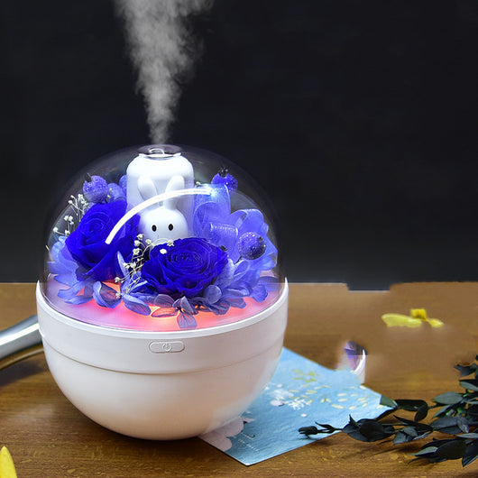 White spherical aroma diffuser with clear dome, featuring preserved blue roses, blue hydrangea, and a white rabbit figurine. - Image 2