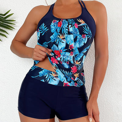 Women's light green high-waisted tankini swimsuit with tropical floral print top and solid swim shorts.
