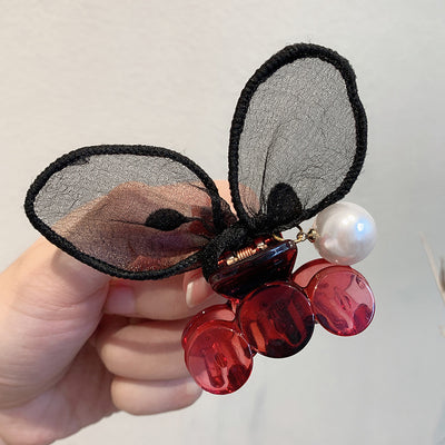 Black sheer polka dot rabbit ears hair claw clip with a faux pearl and gold-toned metal accents. - Image 2