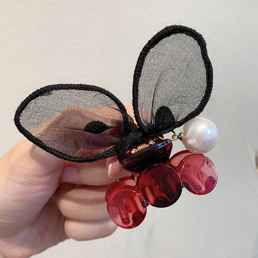 Black sheer polka dot rabbit ears hair claw clip with a faux pearl and gold-toned metal accents. - Image 2