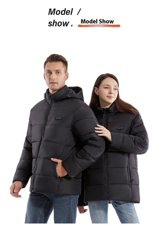 Man and woman modeling black smart heating puffer jackets with hoods, zippered pockets, and horizontal quilting. - Image 14