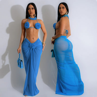Blue three-piece bikini set with floral appliques on the triangle top, thong bottom, and matching ruched maxi skirt. - Image 4