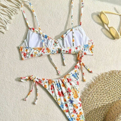 Women's white floral two-piece bikini with red, orange, and blue flowers, featuring a tie-front top and tie-side bottoms. - Image 4
