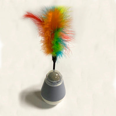 Pink and white tumbler cat toy with a clear dome revealing a catnip ball and a colorful feather wand. - Image 4