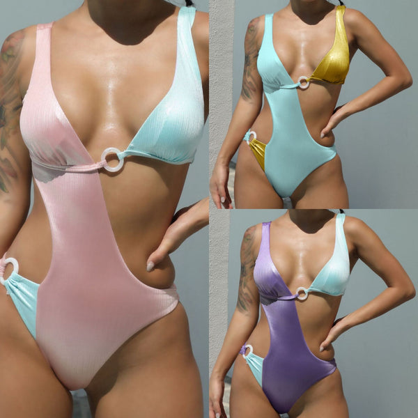 Color block one-piece swimsuit for women, featuring purple and light blue ribbed fabric with cut-outs and O-ring details.