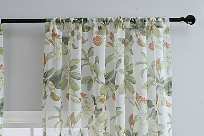 Dark gray semi-sheer curtains with a white and green floral pattern, hung on a black rod in a living room. - Image 14