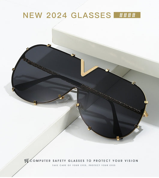 Oversized V-shaped sunglasses with a gold metal frame, white accents, clear lenses, and decorative rivets. - Image 21