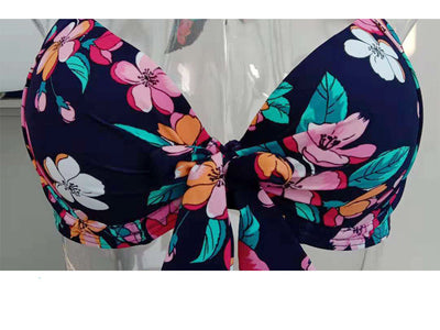 Navy blue floral high-waisted bikini with a halter top and front tie knot, featuring pink, orange, and white flowers. - Image 14