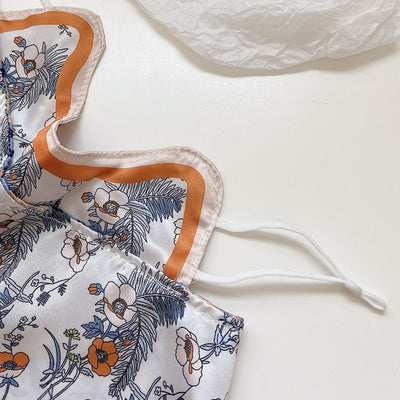 Female cream and black floral polka dot sun protection mask with ear loops, designed for eye corner protection. - Image 34