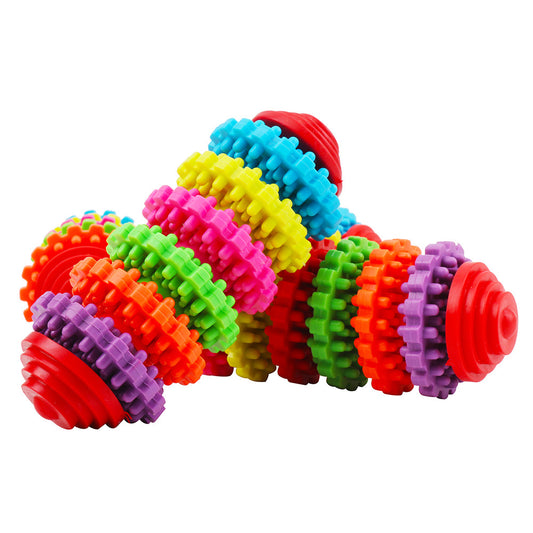 A hand holds a colorful rubber dog toy ball with seven interlocking gear-like rings in purple, orange, green, red, yellow, pink, and blue. - Image 2