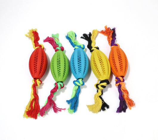 Green rubber pet molar toy with a football shape and textured surface, featuring red and green braided rope knots. - Image 17