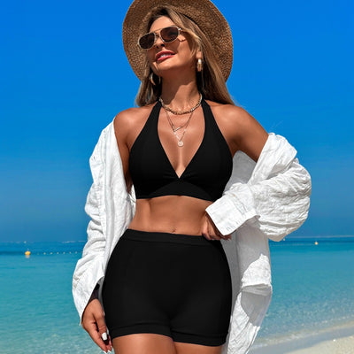 Woman in a hot pink halter neck bikini top and matching high-waisted swim shorts at the beach. - Image 13