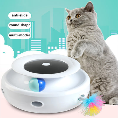 Grey and white cat observing a blue electric cat toy with a feather attachment and glowing blue lights.