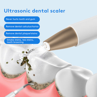 White and gold ultrasonic tooth cleaner with a pointed metal tip, standing in a white charging base. - Image 14