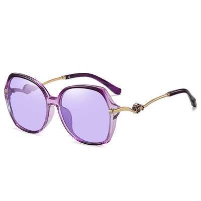 Oversized round-frame sunglasses with pink polarized lenses, translucent pink and brown frame, and gold floral temple accents. - Image 4