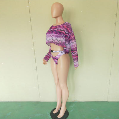 Woman in a purple and pink snakeskin print three-piece swimsuit with an off-shoulder crop top and high-waisted bottoms. - Image 22