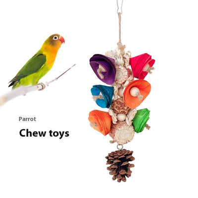 Blue parrot playing with a colorful natural material bird toy featuring corn cobs, wood, and pinecones, hanging in a white birdcage. - Image 5