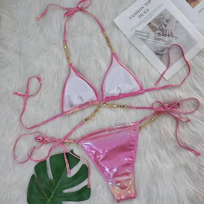 Iridescent purple and pink two-piece bikini with gold-toned crystal embellishments on a white faux fur background. - Image 3