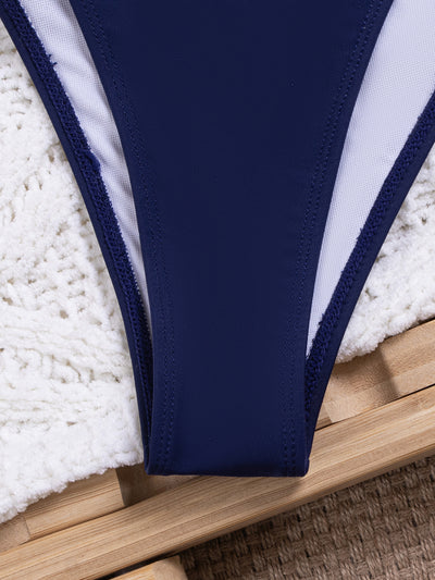 Navy blue bikini swimsuit set with pink floral lace trim on triangle top and tie-side bottoms, on a white knit blanket. - Image 15