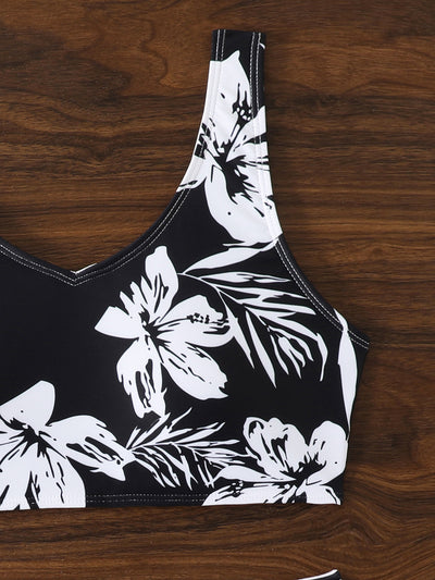 Women's two-piece swimsuit with black and purple floral print. Features a V-neck sports bra top and mid-rise bottom. - Image 27