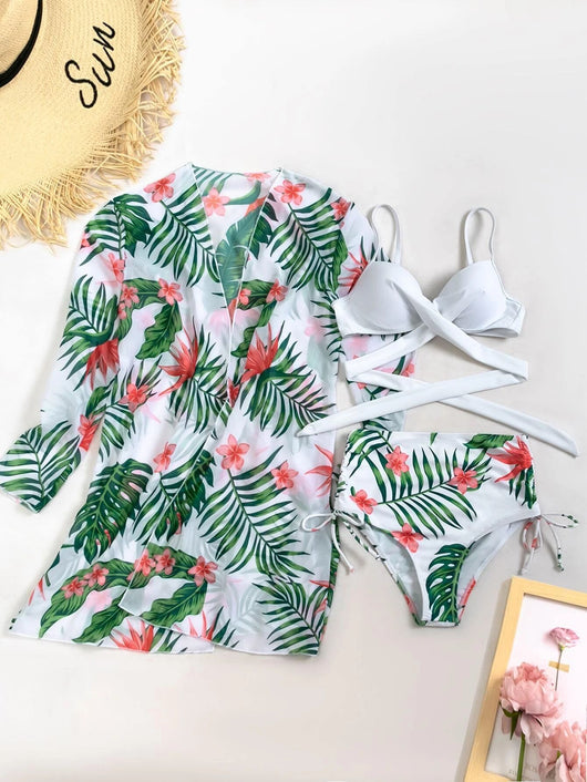 White criss-cross bikini top with high-waisted tropical floral print bottoms and matching long-sleeved cover-up. - Image 8