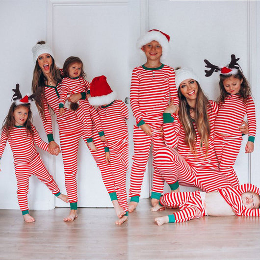 Family of six wearing matching red and white striped long-sleeved pajamas with green cuffs and festive hats. - Image 23