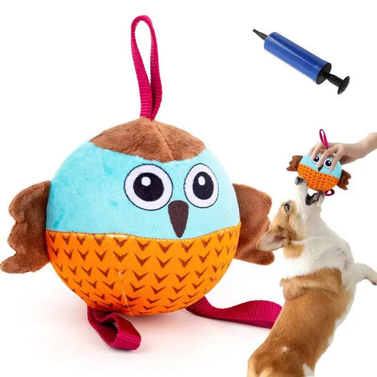 Plush owl dog chew toy in blue, brown, and orange with a chevron pattern, featuring a hanging loop. Measures 13.5cm.