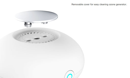 White mini ozone generator and air purifier with a round, compact design and a green indicator light. - Image 9