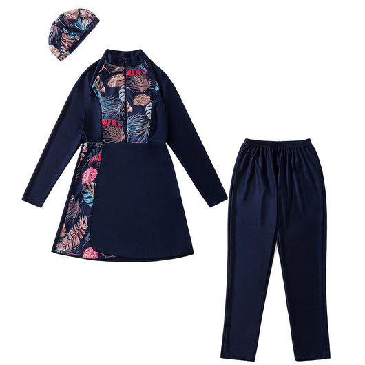 Woman in a navy blue quick-drying conservative swimwear set with a tropical leaf print tunic and matching swim cap. - Image 4