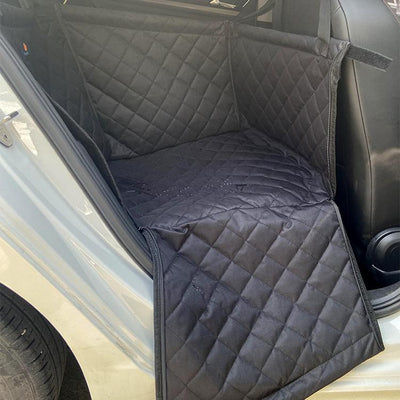 Golden retriever in a dark grey quilted pet car seat, secured in the back seat of a car. - Image 9