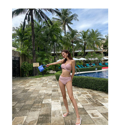 Woman in a pink two-piece bikini with a wrap-style top and high-waist ruched bottoms by a swimming pool. - Image 7