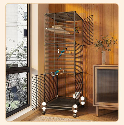 Large black metal bird cage with two columns and three levels, including perches, platforms, food bowls, and a pull-out tray. Two parrots are visible inside. - Image 7